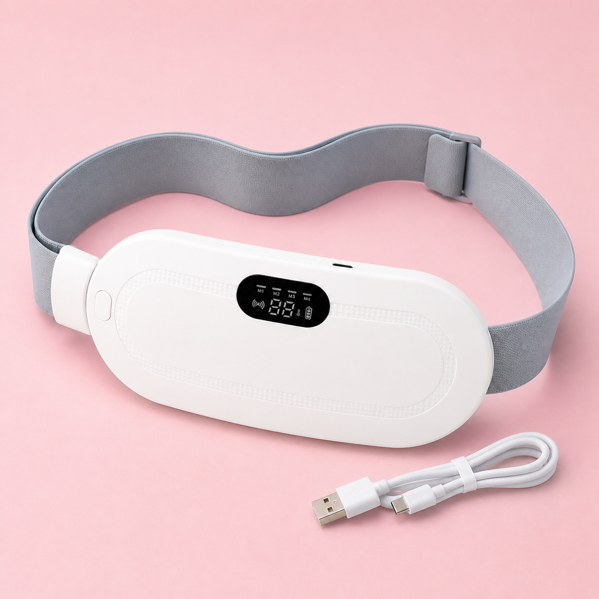 White Cozy Heat Period Relief Pad with its USB charging cable on a pale-pink background